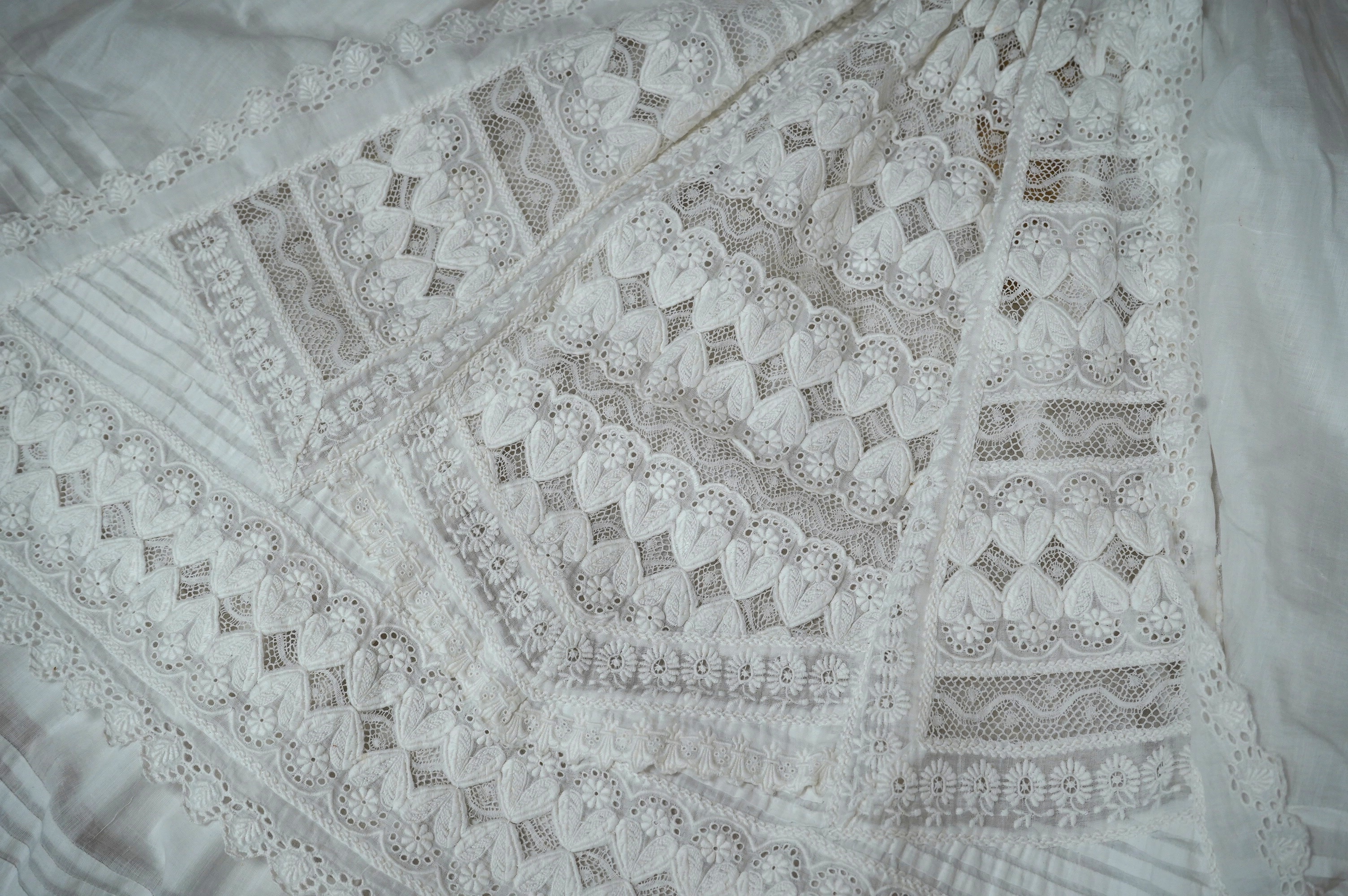 Two unusual 19th century intricately white worked children’s dresses, one hand worked with fine panels of white work, feather stitching and tucking, edged and inserted with hand made Valenciennes lace, the other worked i